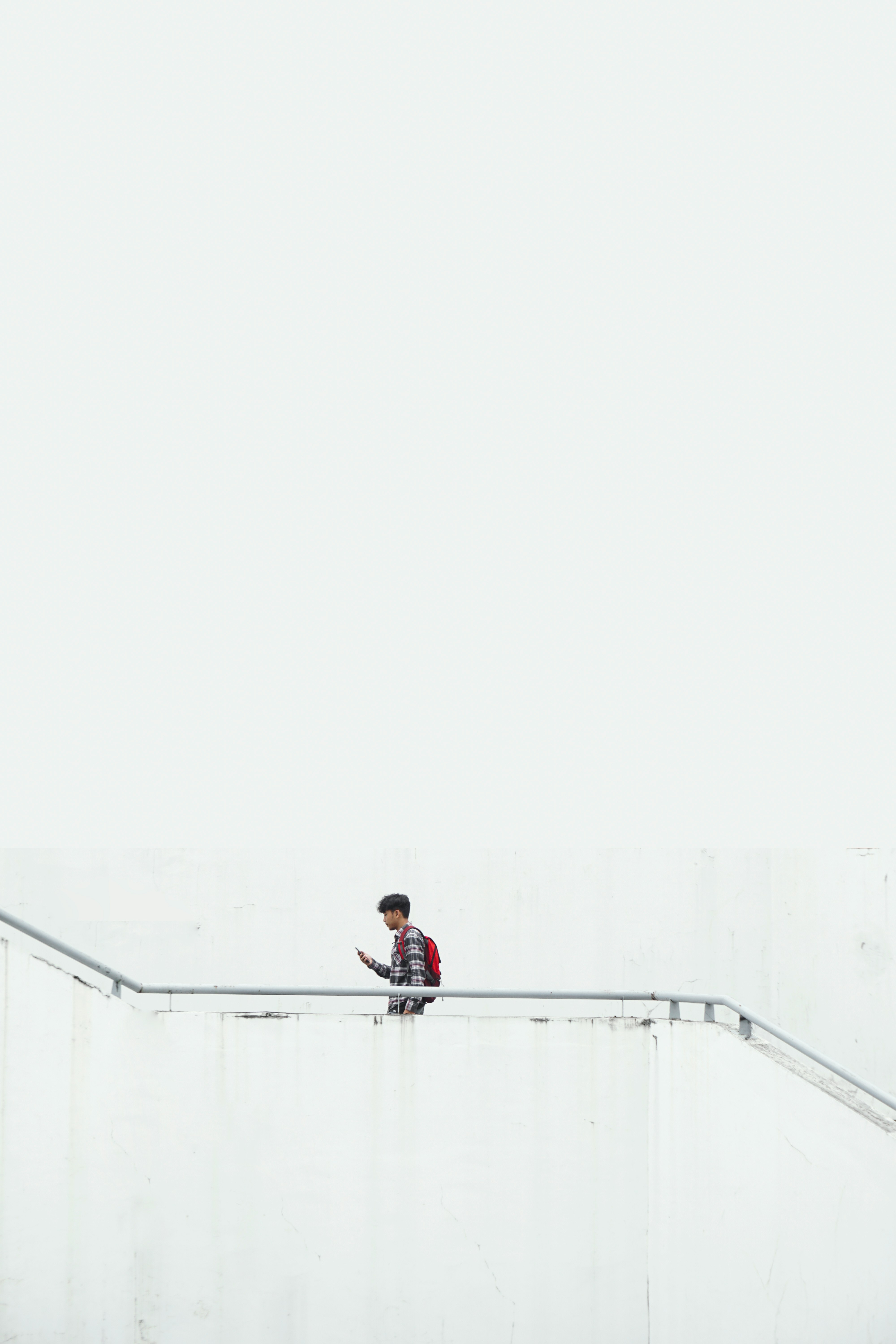 man on stair wearing red backpack